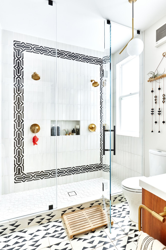 Photo of a mid-sized eclectic bathroom in San Francisco with a freestanding vanity, flat-panel cabinets, medium wood cabinets, a double shower, a two-piece toilet, black and white tile, ceramic tile, cement tiles, an undermount sink, engineered quartz benchtops, white floor, a hinged shower door, white benchtops, a niche and a single vanity.