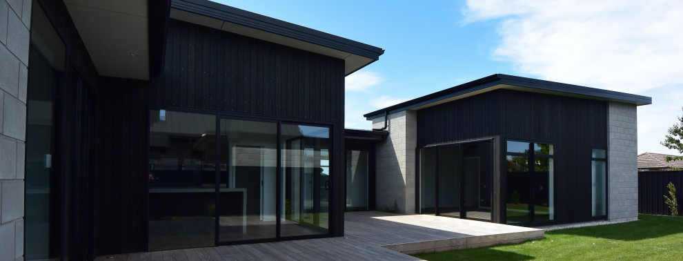 Diseño de fachada negra y negra minimalista con revestimiento de hormigón