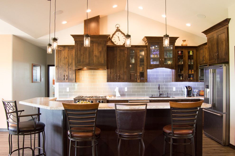 Inspiration for a rustic l-shaped brown floor eat-in kitchen remodel with shaker cabinets, brown cabinets, laminate countertops, gray backsplash, stainless steel appliances, an island and beige countertops