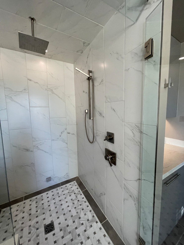Inspiration for a large contemporary master black and white tile and porcelain tile porcelain tile, gray floor, double-sink and wainscoting freestanding bathtub remodel in Phoenix with flat-panel cabinets, gray cabinets, a two-piece toilet, gray walls, an undermount sink, quartz countertops, a hinged shower door, white countertops, a niche and a built-in vanity