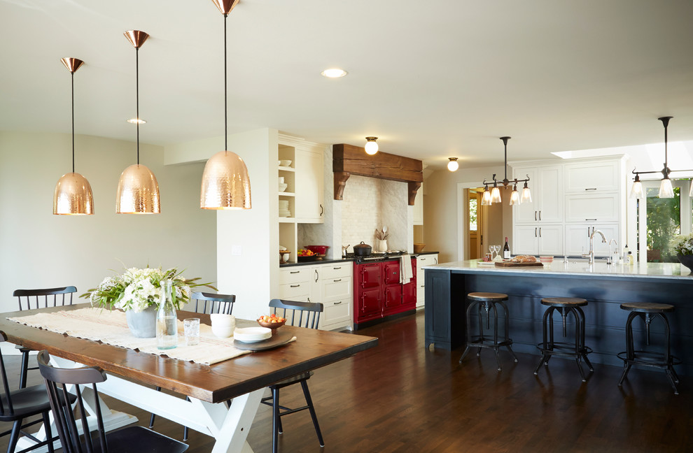 Example of a mountain style kitchen design in Seattle with shaker cabinets, white cabinets, white backsplash, stone tile backsplash and an island