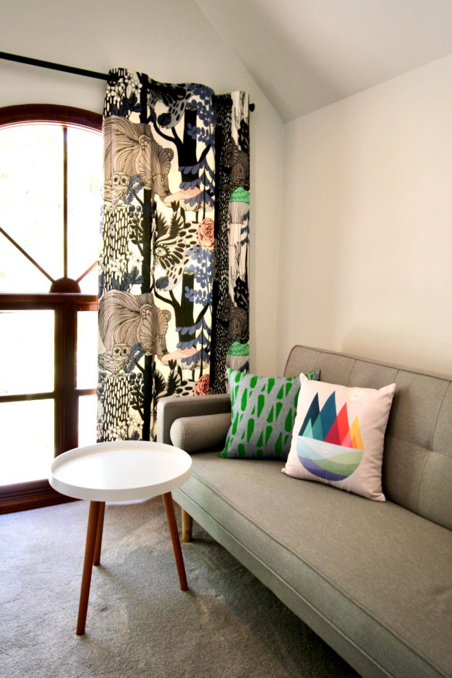 Photo of a small scandinavian gender-neutral kids' room in Sydney with white walls, carpet, grey floor and vaulted.