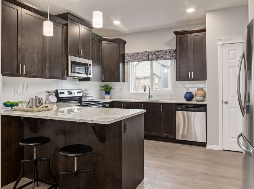 Design ideas for a mid-sized contemporary l-shaped eat-in kitchen in Calgary with an undermount sink, shaker cabinets, brown cabinets, granite benchtops, white splashback, ceramic splashback, stainless steel appliances, linoleum floors, with island and beige floor.