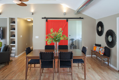 Red barn door with full view of dining table.