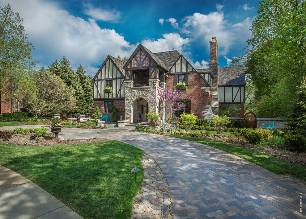 Large transitional multicolored two-story brick exterior home idea in Chicago with a hip roof