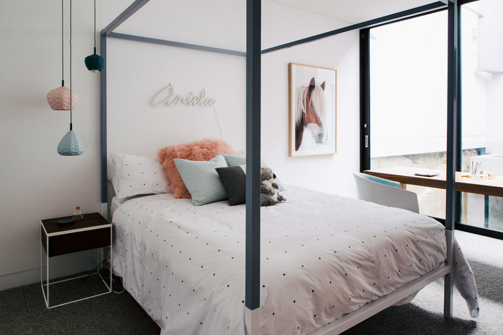 Photo of an expansive contemporary gender-neutral kids' room in Sydney with red walls, carpet and grey floor.