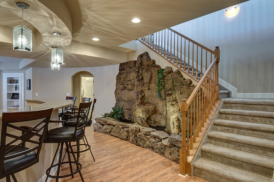 Basement - huge traditional look-out vinyl floor and brown floor basement idea in Denver with beige walls and no fireplace