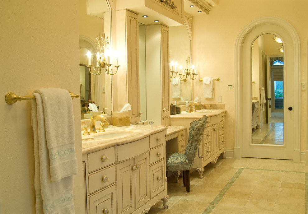 Photo of a traditional master bathroom in Tampa with furniture-like cabinets, white cabinets and onyx benchtops.