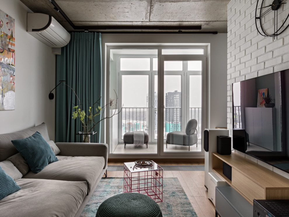 Immagine di un piccolo soggiorno industriale chiuso con pareti bianche, pavimento in legno massello medio, nessun camino, TV a parete e pavimento marrone