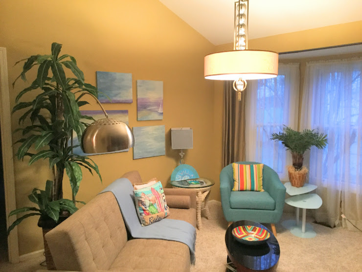 This is an example of a mid-sized transitional enclosed living room in Phoenix with yellow walls and carpet.