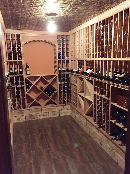 This is an example of a mid-sized transitional wine cellar in New York.