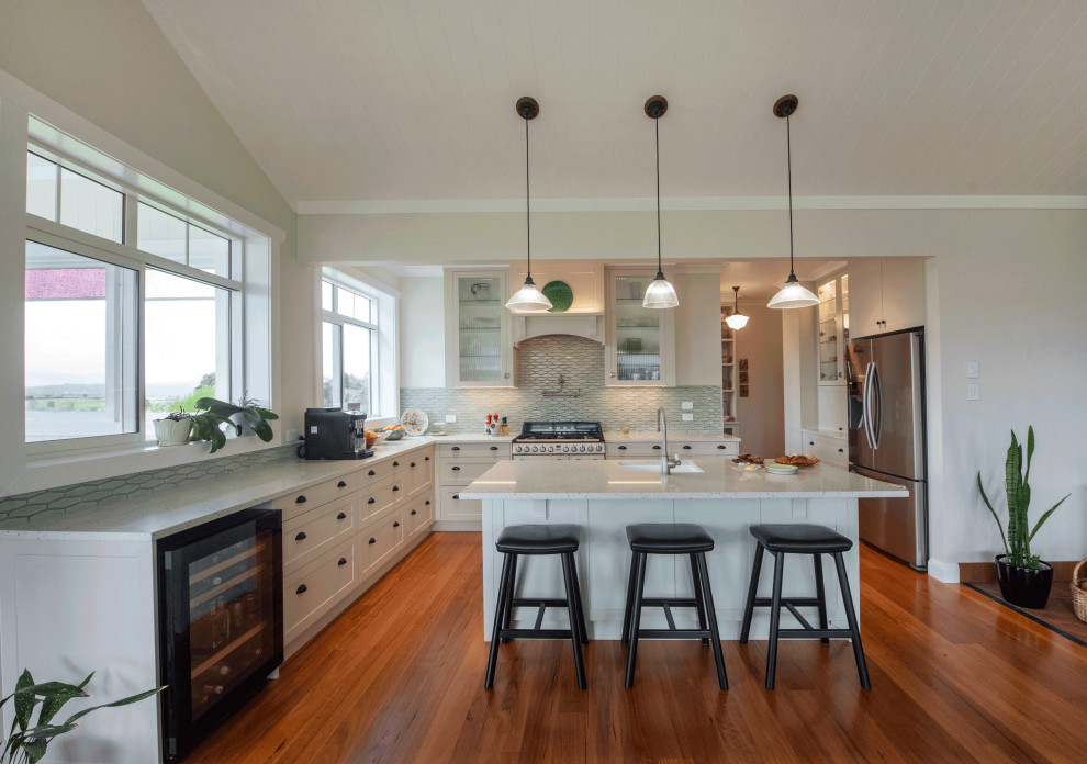 Large classic open plan kitchen in Hamilton with a built-in sink, shaker cabinets, green cabinets, quartz worktops, green splashback, mosaic tiled splashback, dark hardwood flooring, an island, white worktops and a vaulted ceiling.
