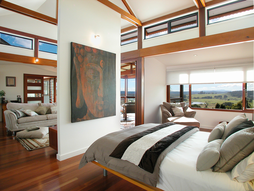 Inspiration for a contemporary bedroom in Brisbane with white walls and medium hardwood floors.