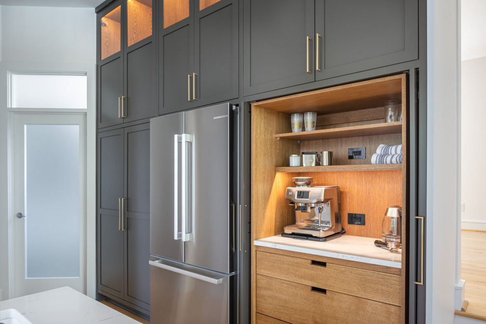 Inspiration for a large transitional u-shaped medium tone wood floor and brown floor kitchen remodel in Raleigh with shaker cabinets, quartz countertops and white countertops