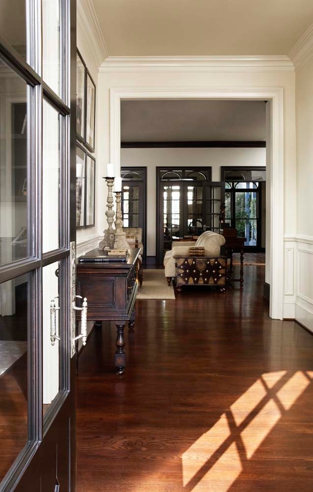 Large traditional hallway in Other with beige walls and dark hardwood floors.