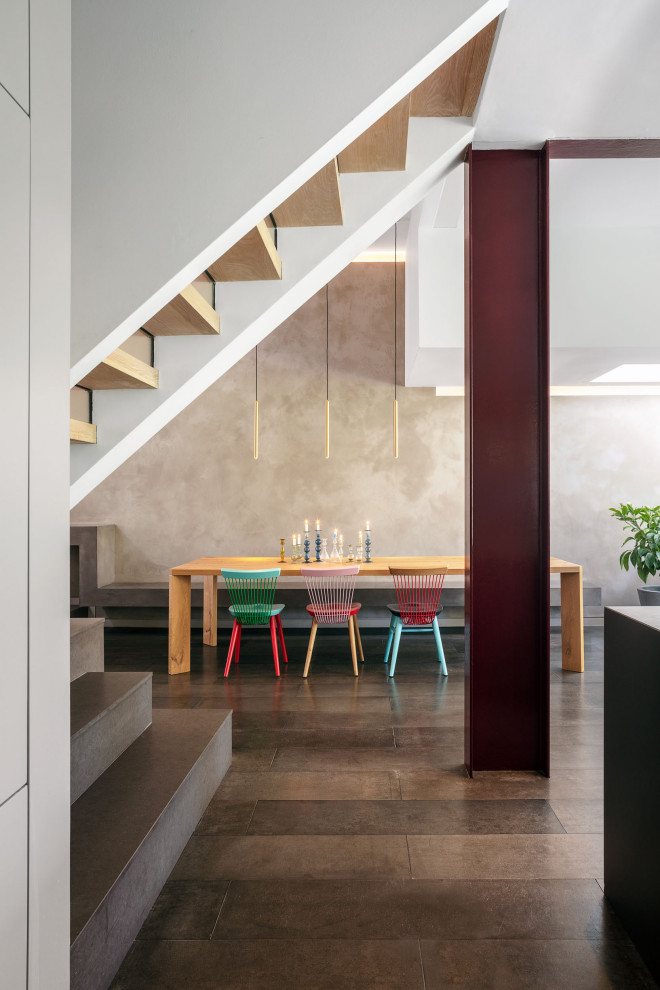 Inspiration for an expansive contemporary open plan dining in London with multi-coloured walls, concrete floors, grey floor and recessed.