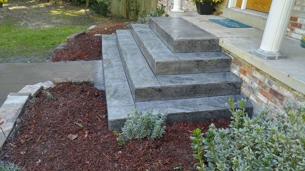 Photo of a small traditional front yard verandah in Other with stamped concrete.
