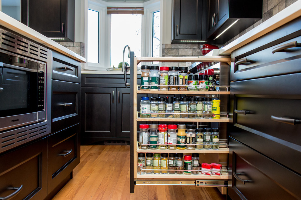 Example of a transitional kitchen design in Calgary