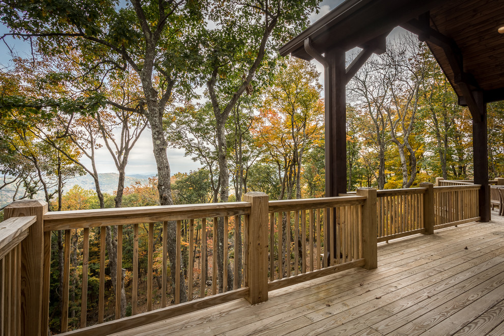Photo of a large country side yard deck in Charlotte with a fire feature and no cover.