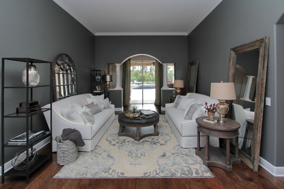 This is an example of a mid-sized contemporary formal enclosed living room in Tampa with grey walls, medium hardwood floors, no fireplace, no tv and brown floor.