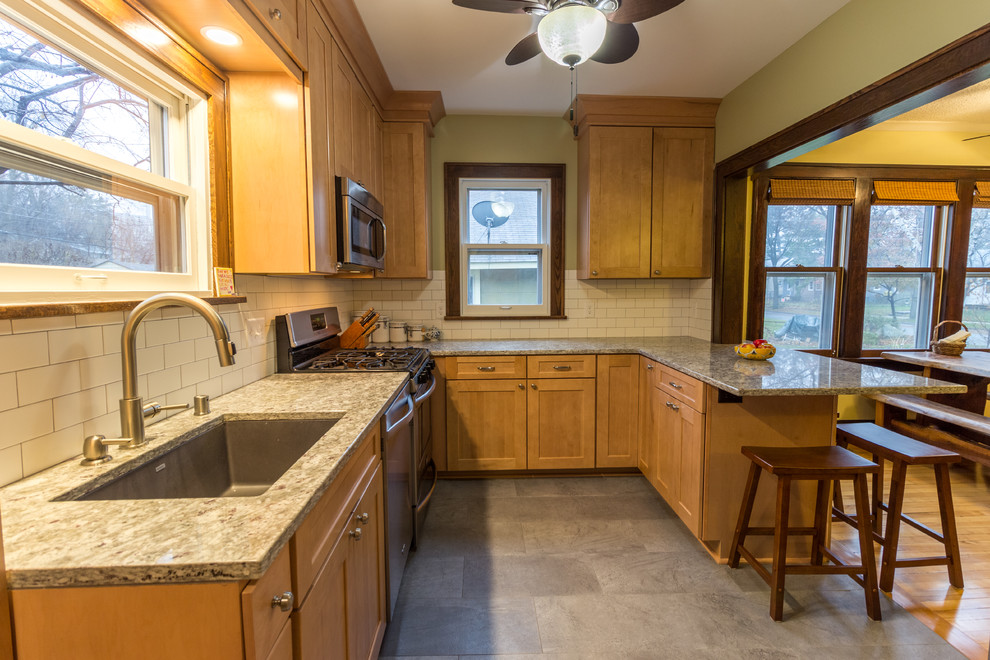 Design ideas for a traditional kitchen in Minneapolis with shaker cabinets, light wood cabinets, granite benchtops, white splashback and vinyl floors.