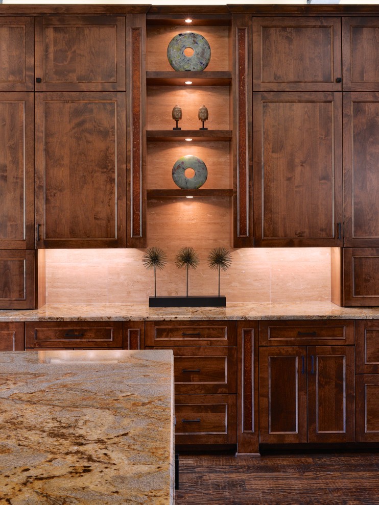 Open concept kitchen - large transitional u-shaped dark wood floor open concept kitchen idea in Dallas with an undermount sink, recessed-panel cabinets, medium tone wood cabinets, granite countertops, beige backsplash, stone tile backsplash, paneled appliances and two islands