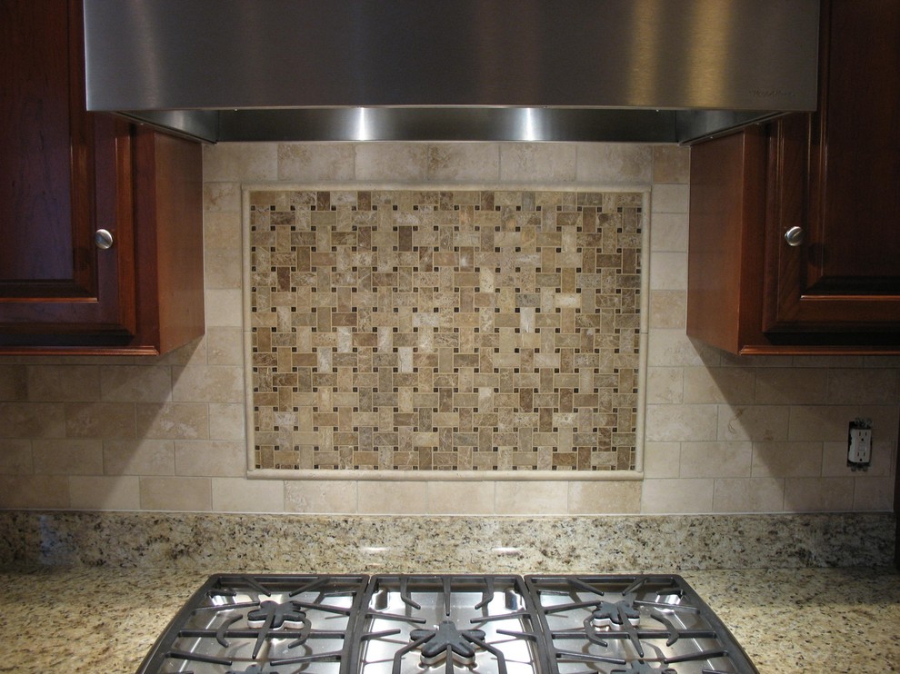 Transitional eat-in kitchen photo in Boston with dark wood cabinets, granite countertops, beige backsplash, stone tile backsplash and stainless steel appliances