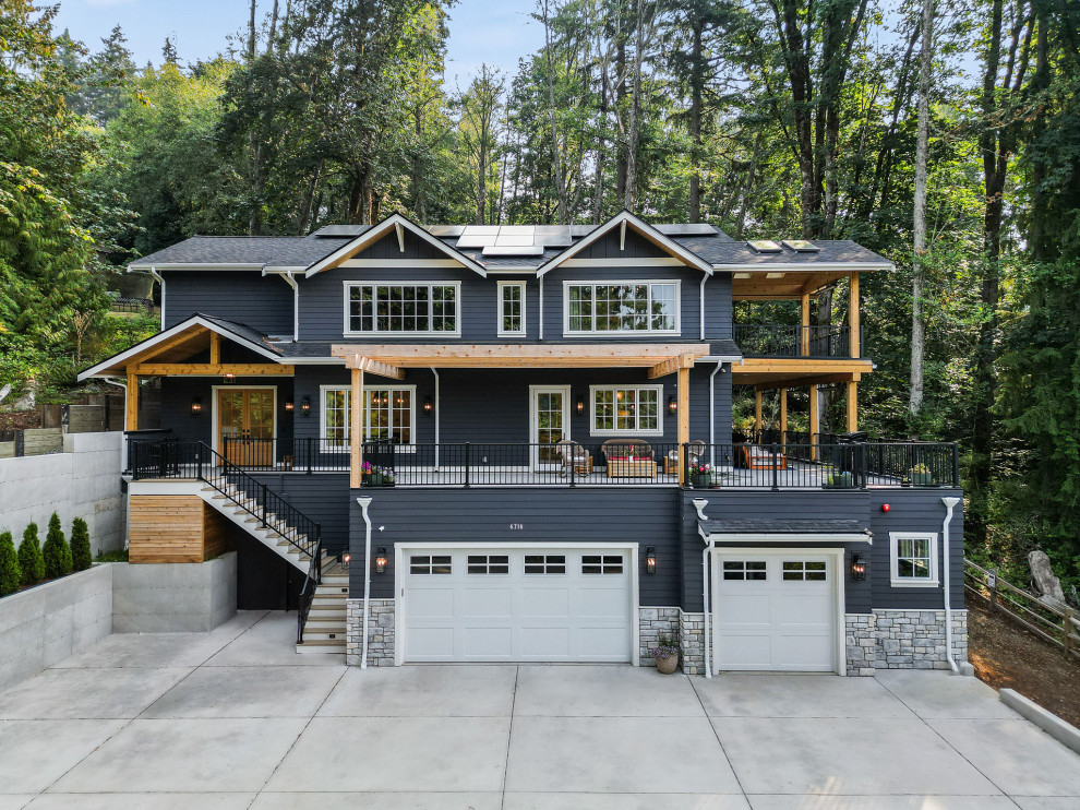 Example of a large transitional blue three-story concrete fiberboard and clapboard exterior home design in Seattle with a shingle roof and a gray roof