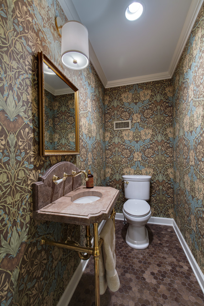 Traditional powder room in Columbus with a two-piece toilet, brown tile, multi-coloured walls, a pedestal sink and brown floor.