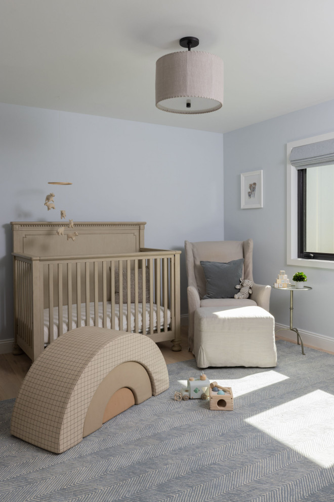 Idées déco pour une chambre de bébé garçon campagne de taille moyenne avec un mur bleu, parquet clair et un sol marron.