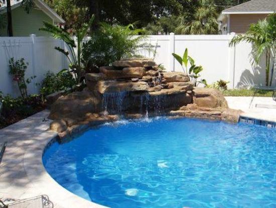 Design ideas for a small transitional backyard round pool in Tampa with concrete pavers.