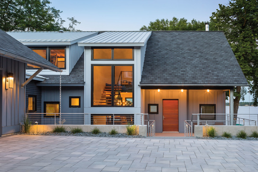 Design ideas for a large contemporary three-storey grey exterior in Minneapolis with metal siding and a gable roof.