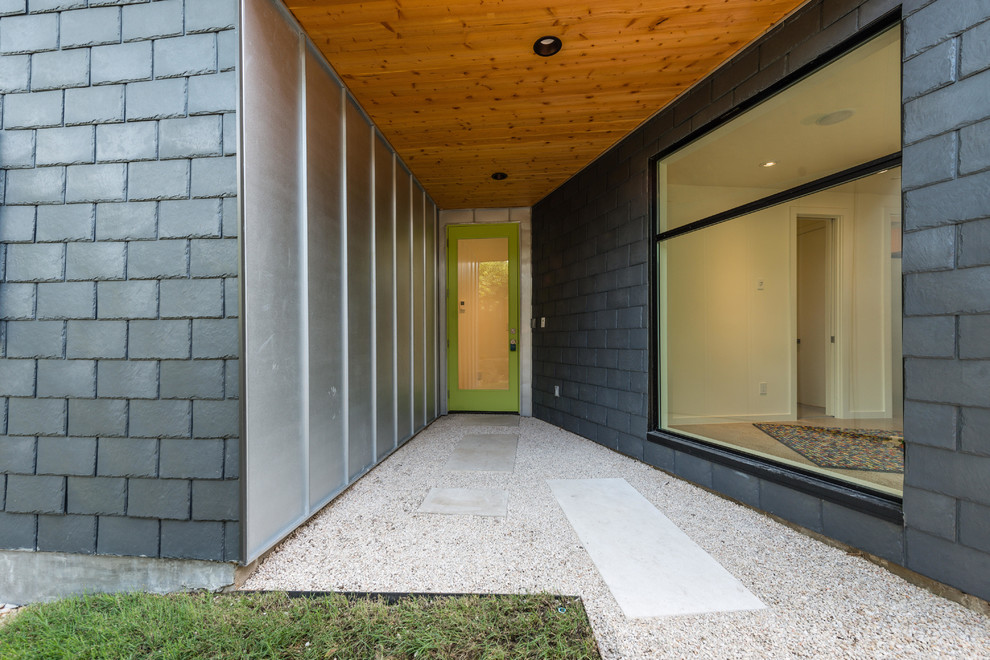 Mid-sized contemporary front door in Austin with beige walls, a single front door and a green front door.