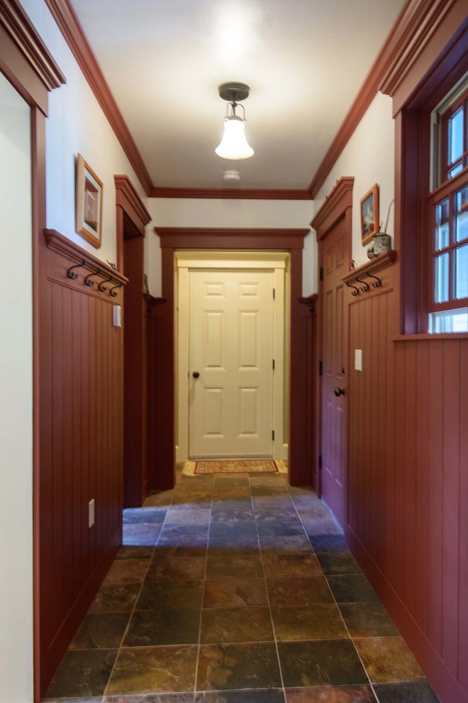 Design ideas for a mid-sized country mudroom in Burlington with red walls, slate floors, a single front door and a red front door.