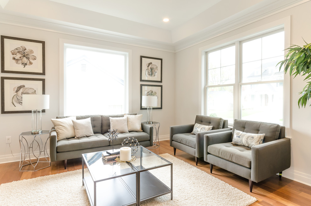 Design ideas for a transitional living room in DC Metro with white walls, medium hardwood floors and brown floor.