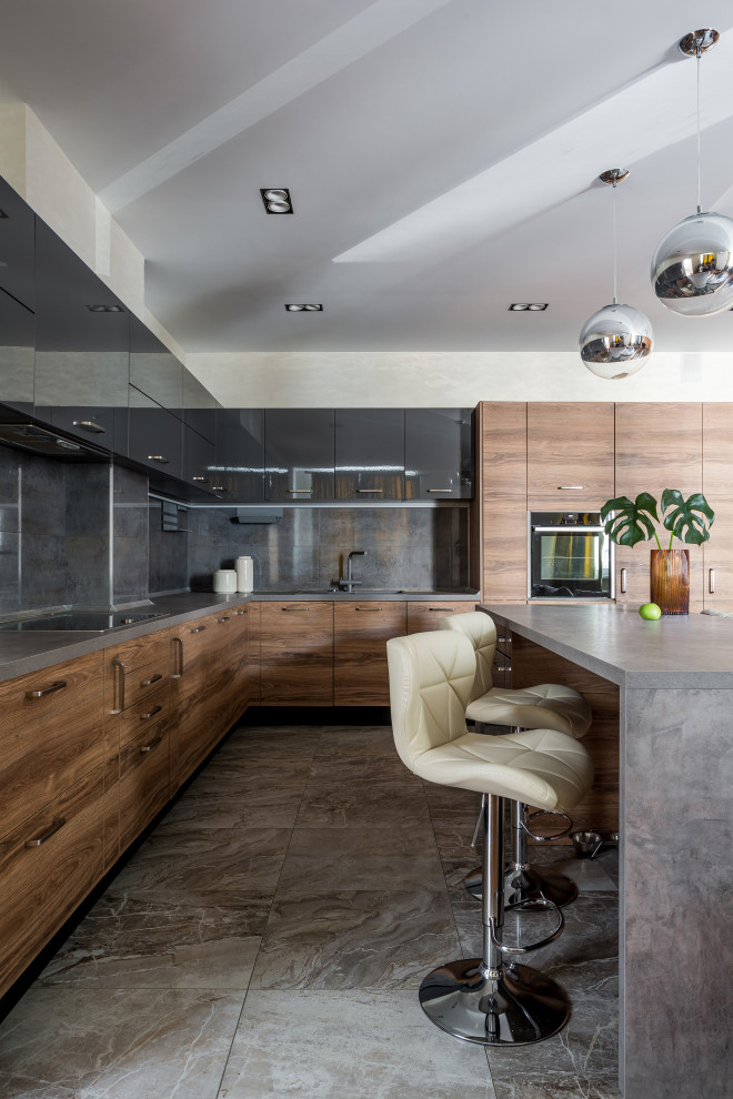 Photo of a contemporary l-shaped kitchen in Other with a drop-in sink, flat-panel cabinets, medium wood cabinets, grey splashback, stainless steel appliances, with island, grey floor and grey benchtop.