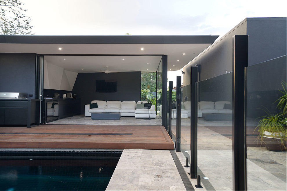 This is an example of a small contemporary front yard rectangular pool in Melbourne with a pool house and tile.