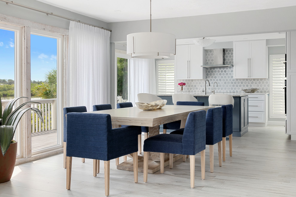 Design ideas for a transitional open plan dining in Tampa with grey walls, light hardwood floors, no fireplace and beige floor.