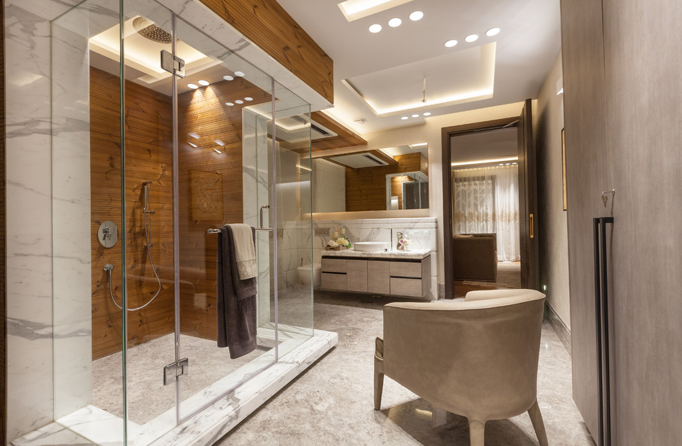 Large contemporary bathroom in Delhi with flat-panel cabinets, a wall-mount toilet, stone slab, a vessel sink and a hinged shower door.