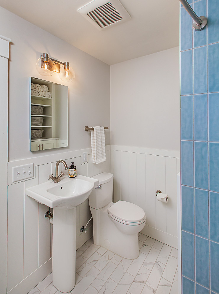 Inspiration for a medium sized traditional family bathroom in Detroit with an alcove bath, a shower/bath combination, a two-piece toilet, porcelain flooring, a pedestal sink, grey floors, a shower curtain, a single sink and tongue and groove walls.