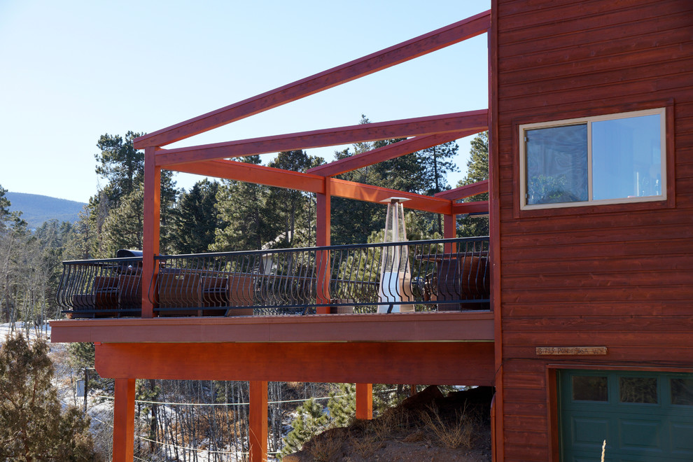 Inspiration for a large rustic deck remodel in Denver with an awning