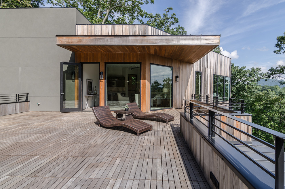 Inspiration for a contemporary deck in Other with a roof extension.