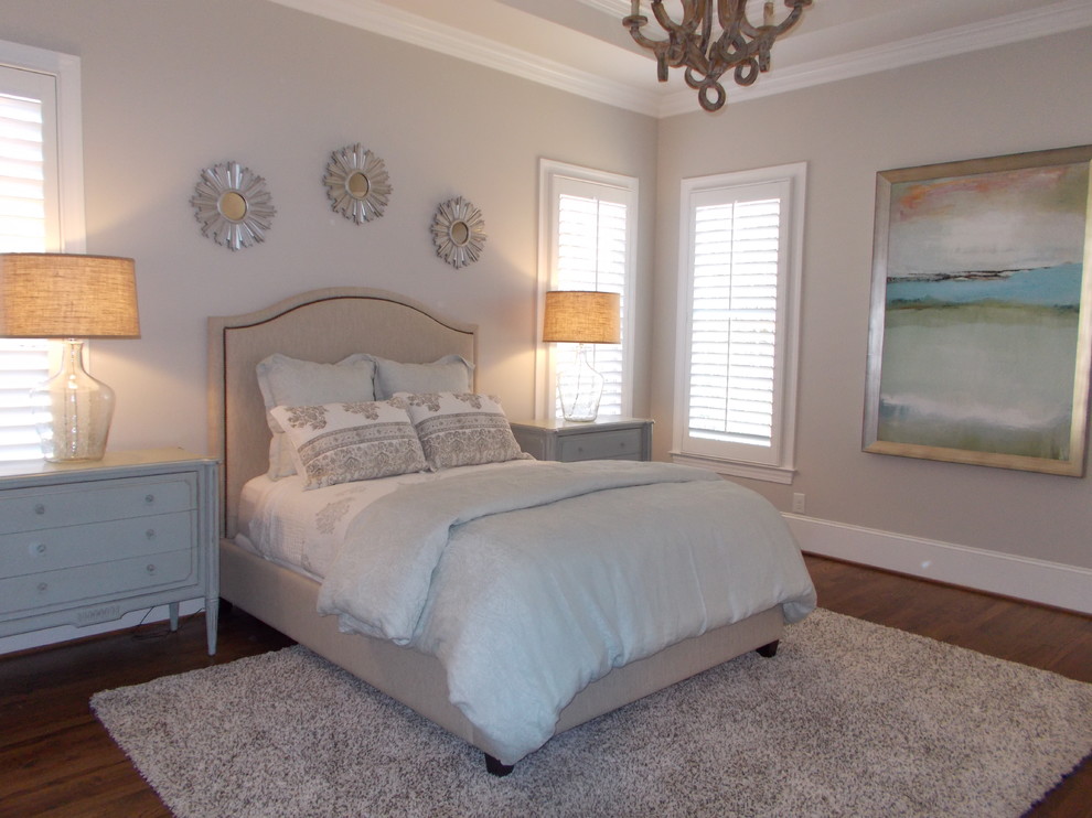Inspiration for a mid-sized transitional master dark wood floor and brown floor bedroom remodel with beige walls
