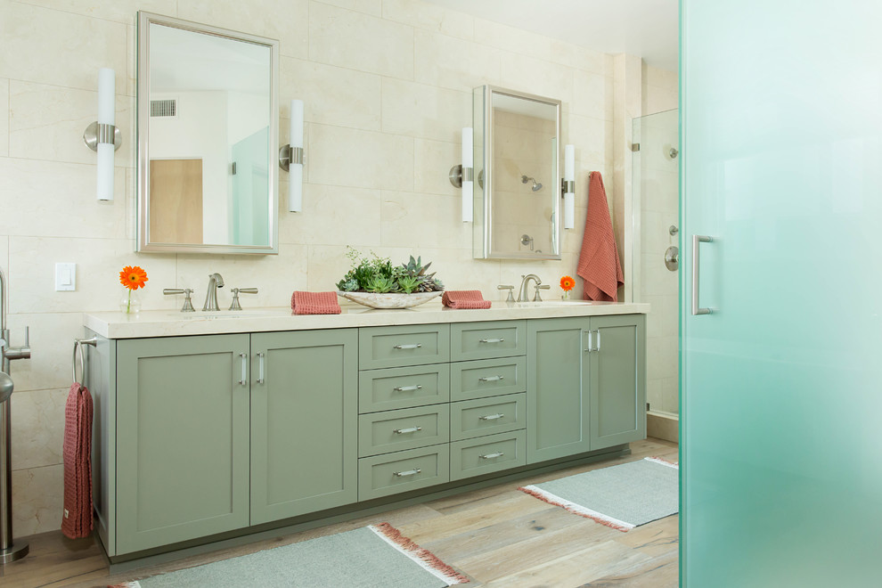 Inspiration for a large beach style master bathroom in Los Angeles with shaker cabinets, green cabinets, a freestanding tub, a double shower, a bidet, beige tile, marble, beige walls, light hardwood floors, a drop-in sink, marble benchtops, grey floor and a hinged shower door.