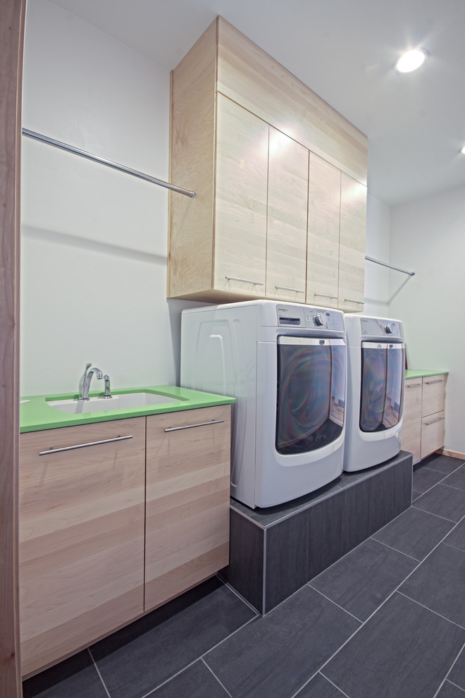Photo of a modern laundry room in Other with green benchtop.