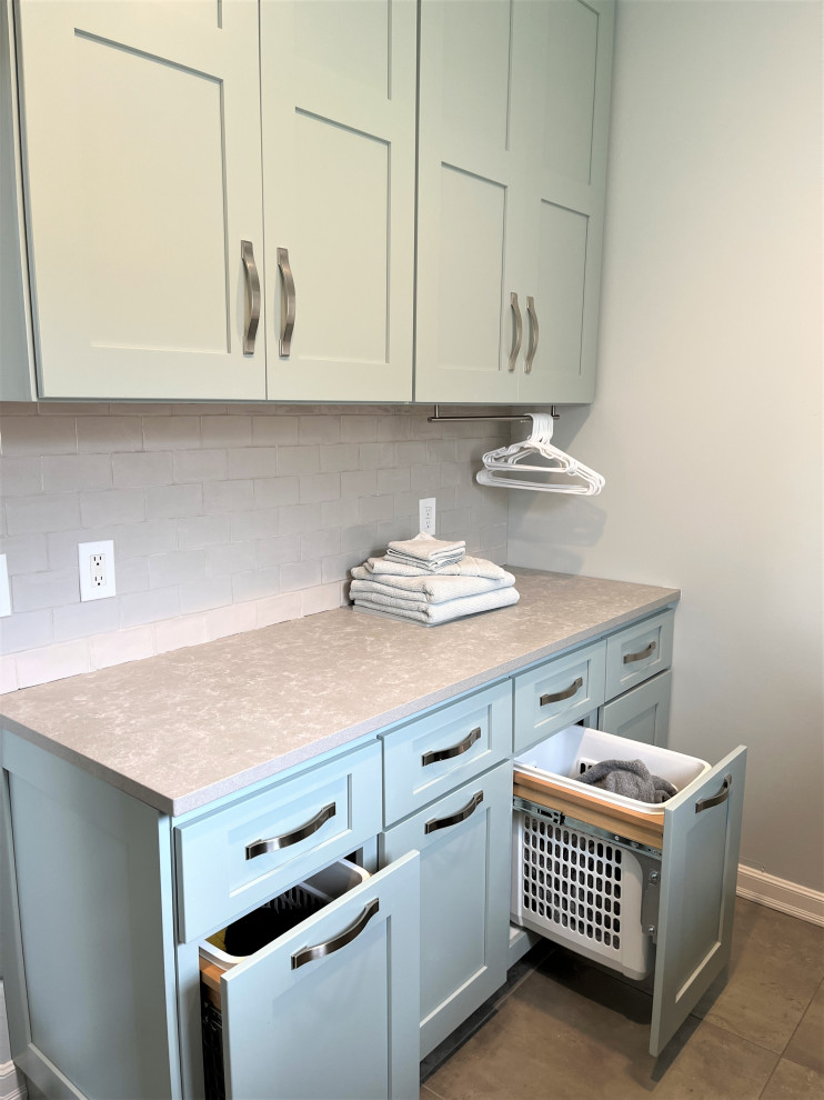 Inspiration for a large galley dedicated laundry room in Detroit with an undermount sink, shaker cabinets, turquoise cabinets, quartz benchtops, white splashback, subway tile splashback, white walls, porcelain floors, a side-by-side washer and dryer, grey floor and grey benchtop.