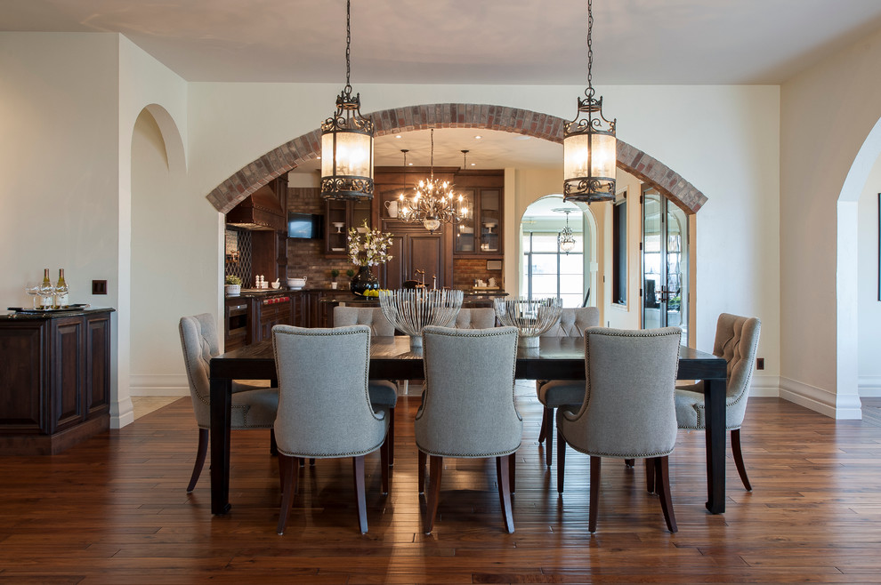 Traditional dining room in Calgary with white walls and medium hardwood floors.