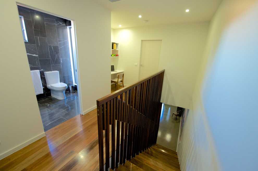 Inspiration for a mid-sized contemporary wood straight staircase in Melbourne with wood risers.