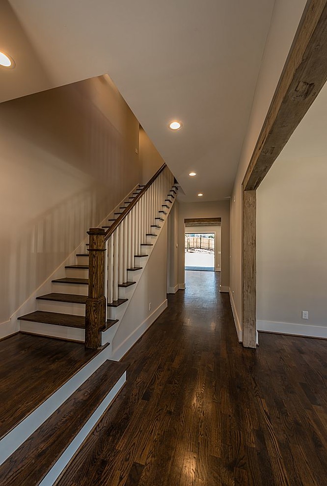 This is an example of a mid-sized entry hall in Atlanta with grey walls, dark hardwood floors, a single front door and a dark wood front door.
