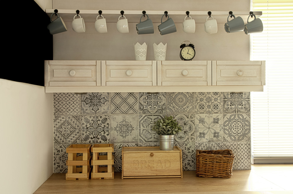 Country kitchen photo with wood countertops, gray backsplash and beige countertops